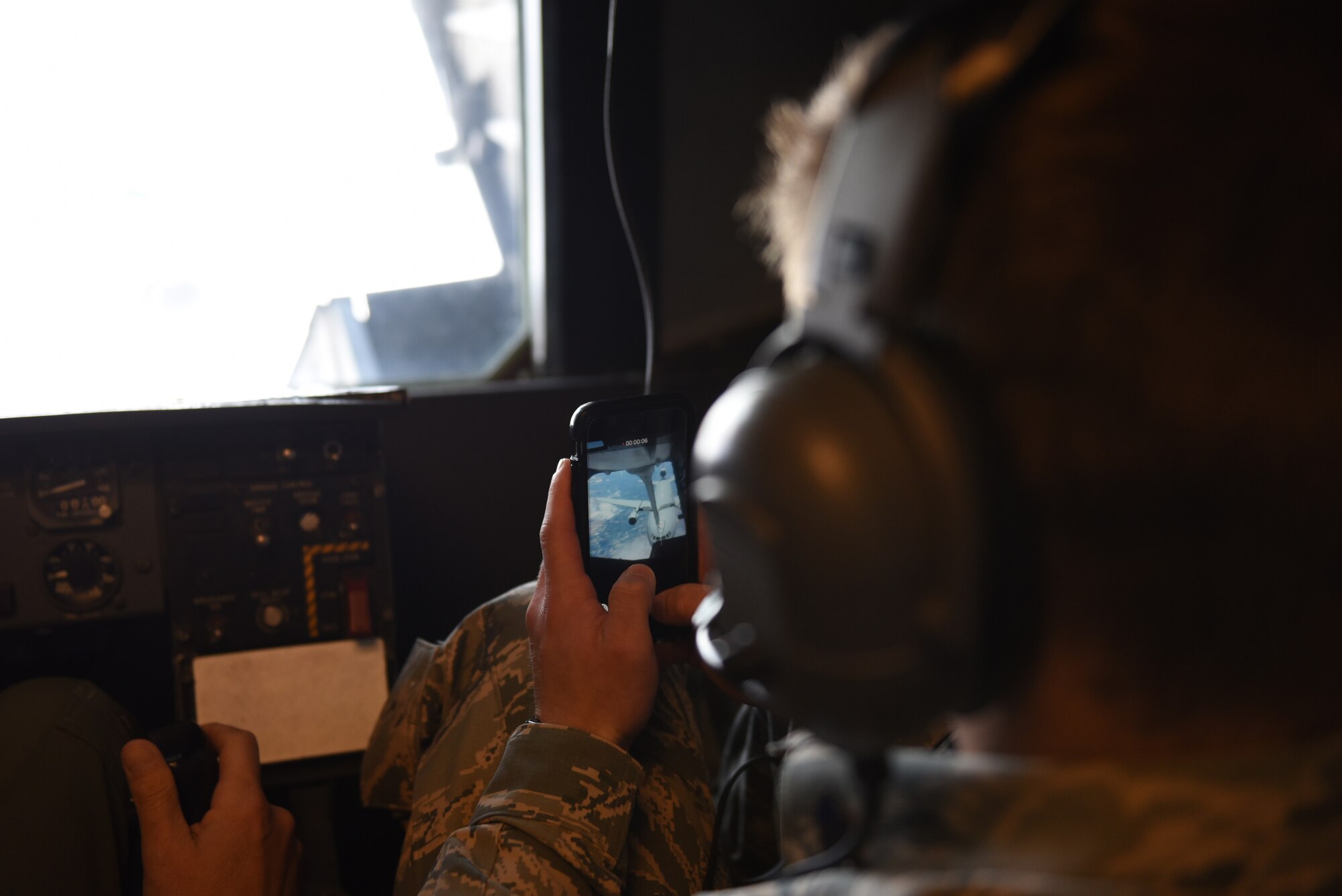 Cadet Nicholas Dintino, a student from Saint Lawrence University, New York, records refueling operations with his cell phone while a KC-10 Extender from Travis Air Force Base, California, refuels another KC-10 May 23, 2019. Twenty-One Air Force Reserve Officer Training Corps cadets visited Travis for close to three weeks to gain a better understanding of the operational Air Force. (U.S. Air Force photo by Airman 1st Class Cameron Otte)