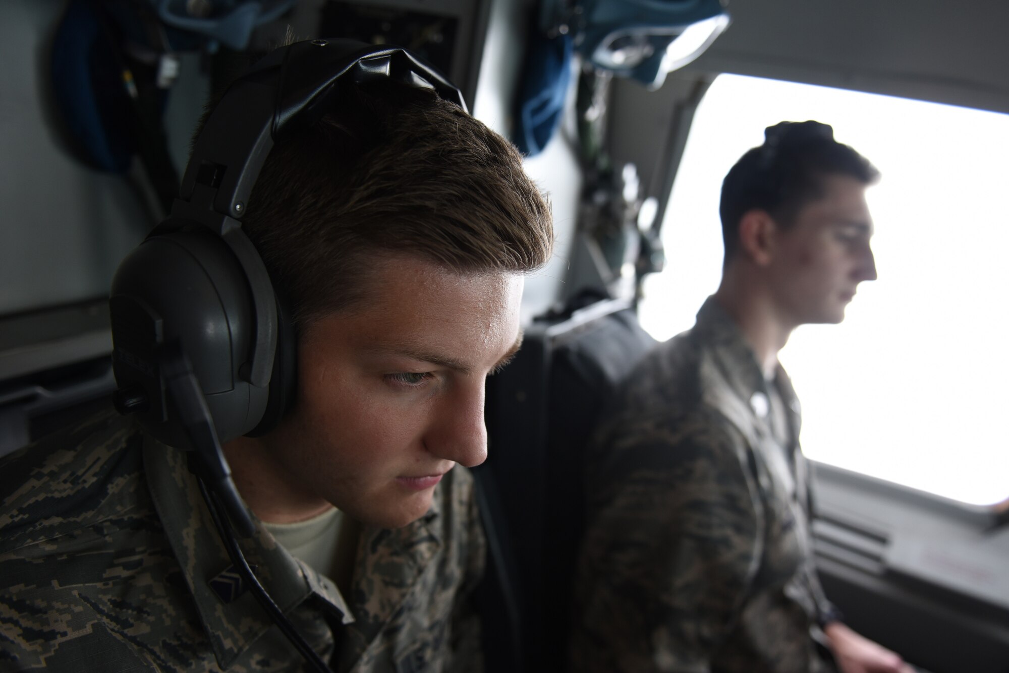 Cadet Nicholas Dintino, a student from Saint Lawrence University, New York, left, and Cadet Drake Paden, a student from Southern Illinois University, sit in the flight deck of a KC-10 Extender during an air refueling mission May 23, 2019, out of Travis Air Force Base, California. Twenty-One Air Force Reserve Officer Training Corps cadets visited Travis for close to three weeks to gain a better understanding of the operational Air Force. (U.S. Air Force photo by Airman 1st Class Cameron Otte)