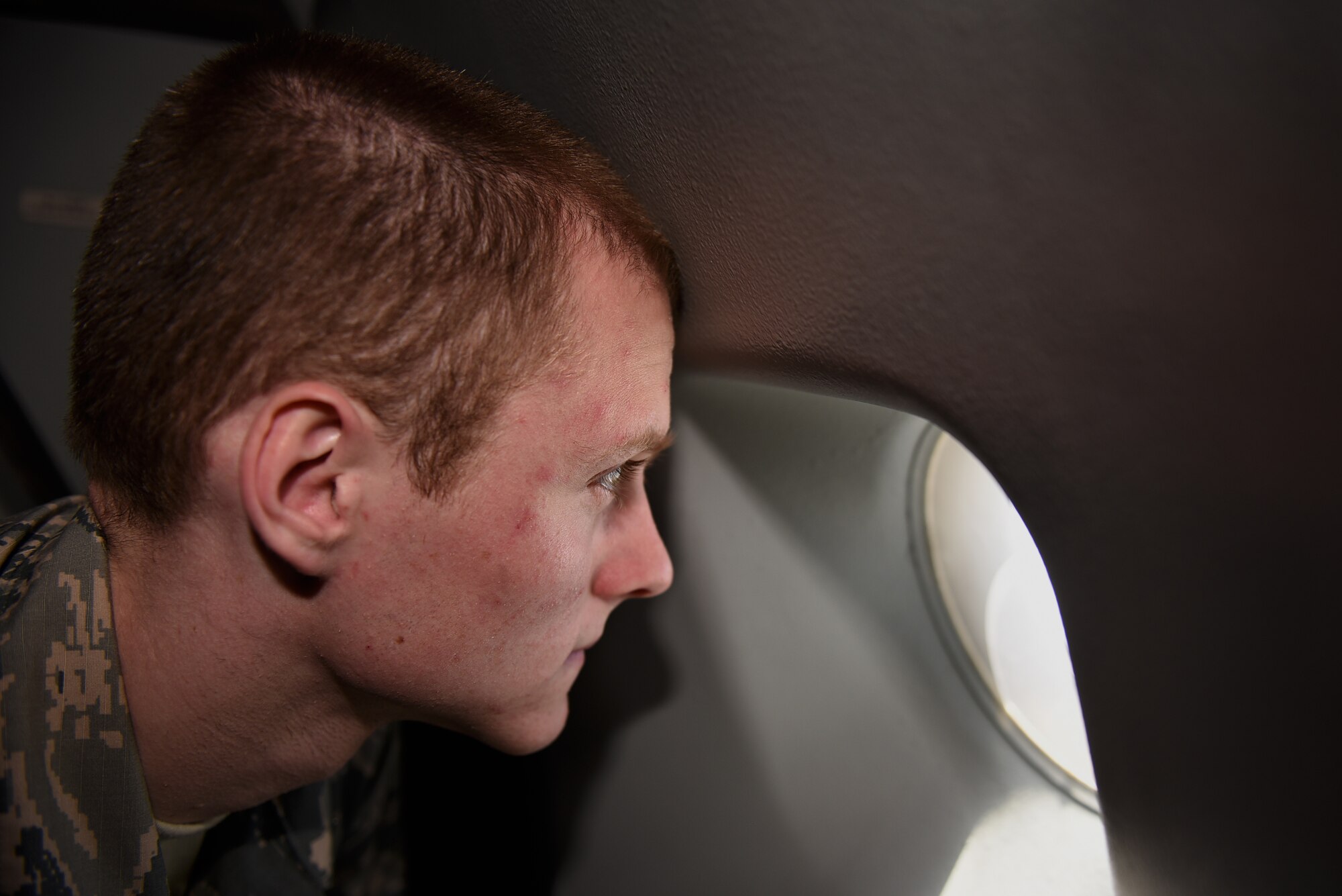 Cadet Joel Stahr, a student from Cedarville University, Ohio, looks out the window of a KC-10 Extender from Travis Air Force Base, California, May 23, 2019. Twenty-One Air Force Reserve Officer Training Corps cadets visited Travis for close to three weeks to gain a better understanding of the operational Air Force. (U.S. Air Force photo by Airman 1st Class Cameron Otte)