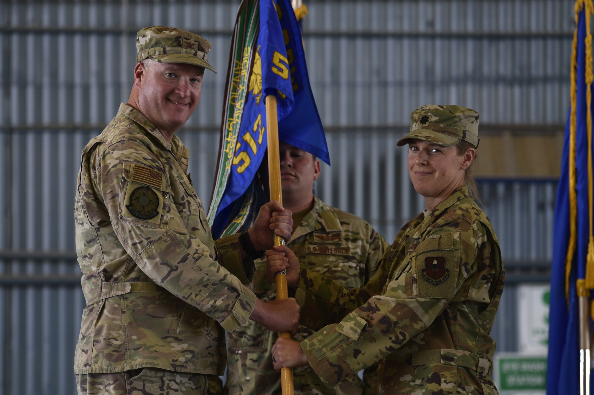 U.S. Air Force Lt. Col. Dana Bochte (right), 512th Rescue Squadron commander, receives command of the 512 RQS from U.S. Air Force Col. Richard Carrell, 58th Operations Group commander during the 512th RQS change of command ceremony at Kirtland Air Force Base, N.M., May 23, 2019. The mission of the 512 RQS is to prepare mission-ready aircrew for personnel recovery, nuclear enterprise security and support, and distinguished visitor airlift at operational units across the Air Force. (U.S. Air Force photo by Airman 1st Class Austin J. Prisbrey)