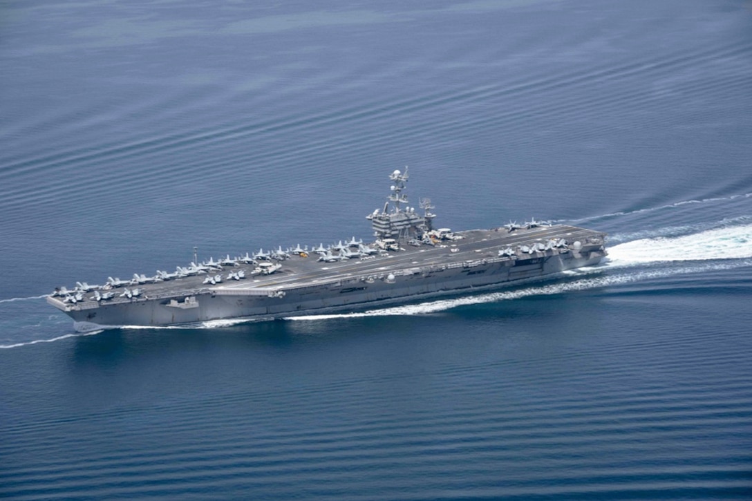 Aircraft carrier moves through the water.