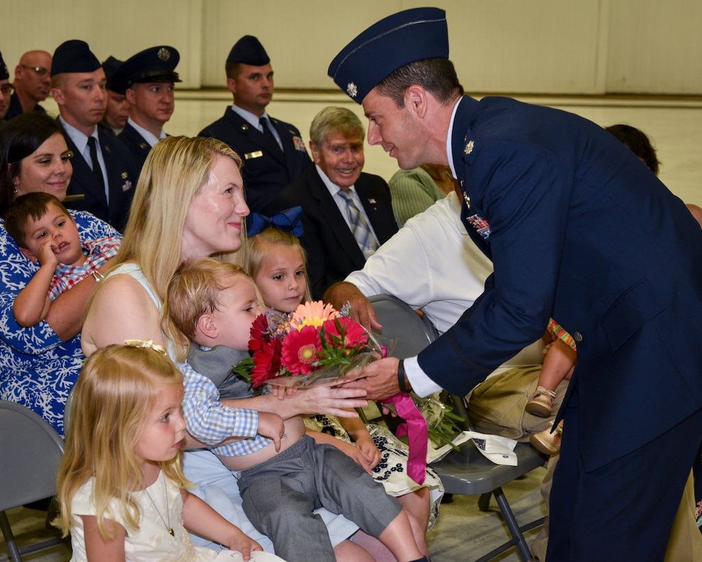 Lt. Col. Curran Presents Flowers To Mrs. Curran and family