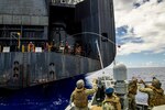 SANTA RITA, Guam (May 24, 2019) Sailors assigned to Coastal Riverine Squadron (CRS) 2, prepare to catch a heaving line from the Military Sealift Command maritime prepositioning force container, roll-on/roll-off and mobile landing platform USNS Dahl (T-AKR 312) during a replenishment-at-sea training exercise near Apra Harbor. CRS-2, assigned to Coastal Riverine Group 1, Det. Guam, is capable of conducting maritime security operations across the full spectrum of naval, joint and combined operations. Further, it provides additional capabilities of port security, embarked security and theater security cooperation around the U.S. 7th Fleet of operations.