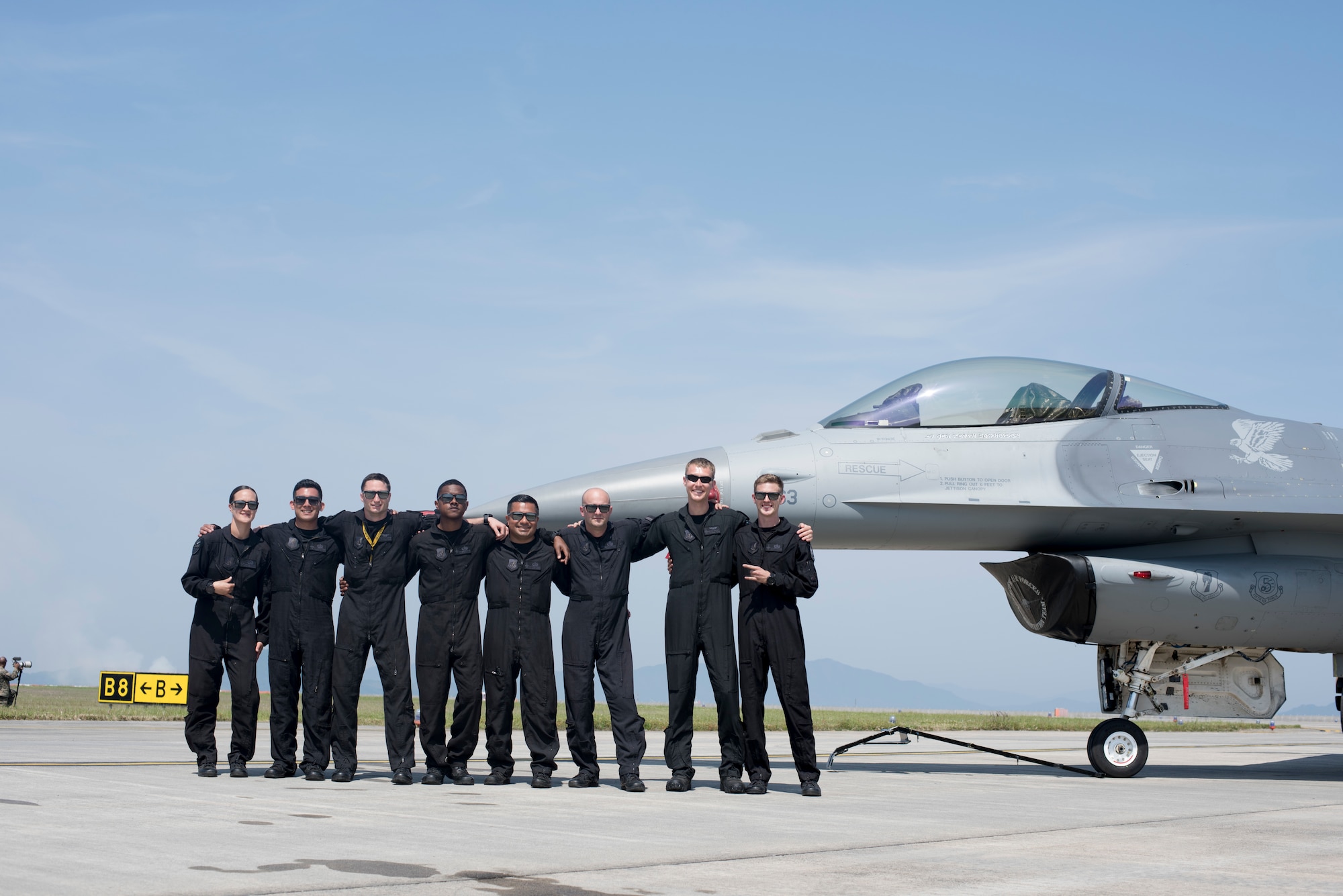 The Pacific Air Forces F-16 Fighting Falcon Demonstration Team pauses for a photo at the 43rd Japan Maritime Self-Defense Force – Marine Corps Air Station Iwakuni Friendship Day 2019 at MCAS Iwakuni, Japan, May 5, 2019. U.S. Air Force Capt. Jacob “Primo” Impellizzeri, the PACAF F-16 Fighting Falcon Demo Team commander and pilot, oversees the team which consists of three crew chiefs, two avionics specialists, one electrical and engineering specialist, one engines maintainer, one superintendent and a safety observer. (U.S. Air Force photo by Senior Airman Collette Brooks)