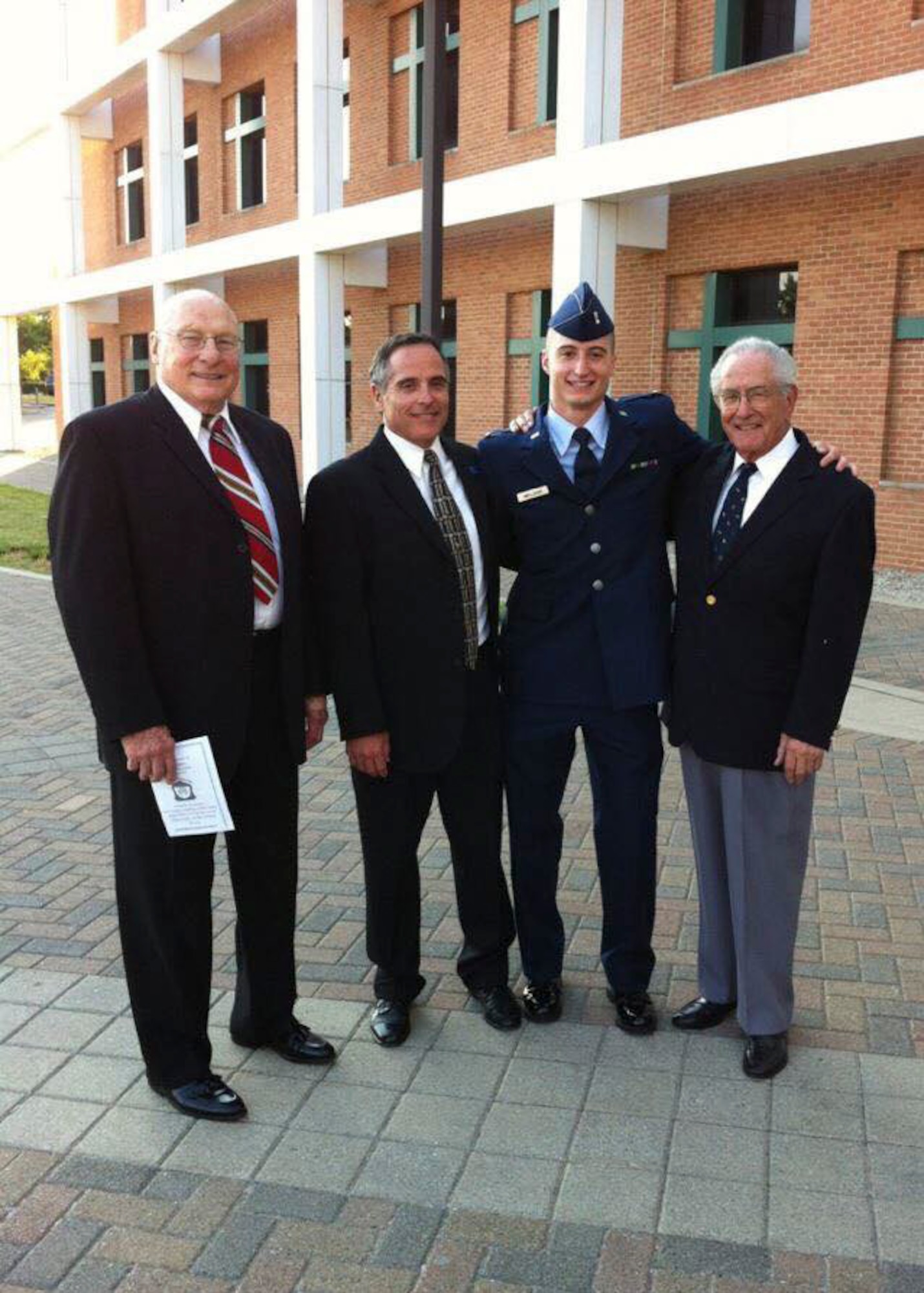 U.S. Air Force Capt. Jacob “Primo” Impellizzeri, center right, the Pacific Air Forces F-16 Fighting Falcon Demonstration Team commander and pilot, pauses for a photo with retired U.S Air Force Col. George Rice, left, his maternal grandfather, and former U.S. Air Force Capt. Ken Impellizzeri, center, his father, and former Cpl. U.S. Army Air Corps Donald Impellizzeri, right, his paternal grandfather, right, after his commissioning ceremony at Wright State University in Dayton, Ohio, June 8, 2012. Post high school graduation Impellizzeri attended the Reserve Officers’ Training Corps program resulting in a continued family legacy of service. (Courtesy photo)