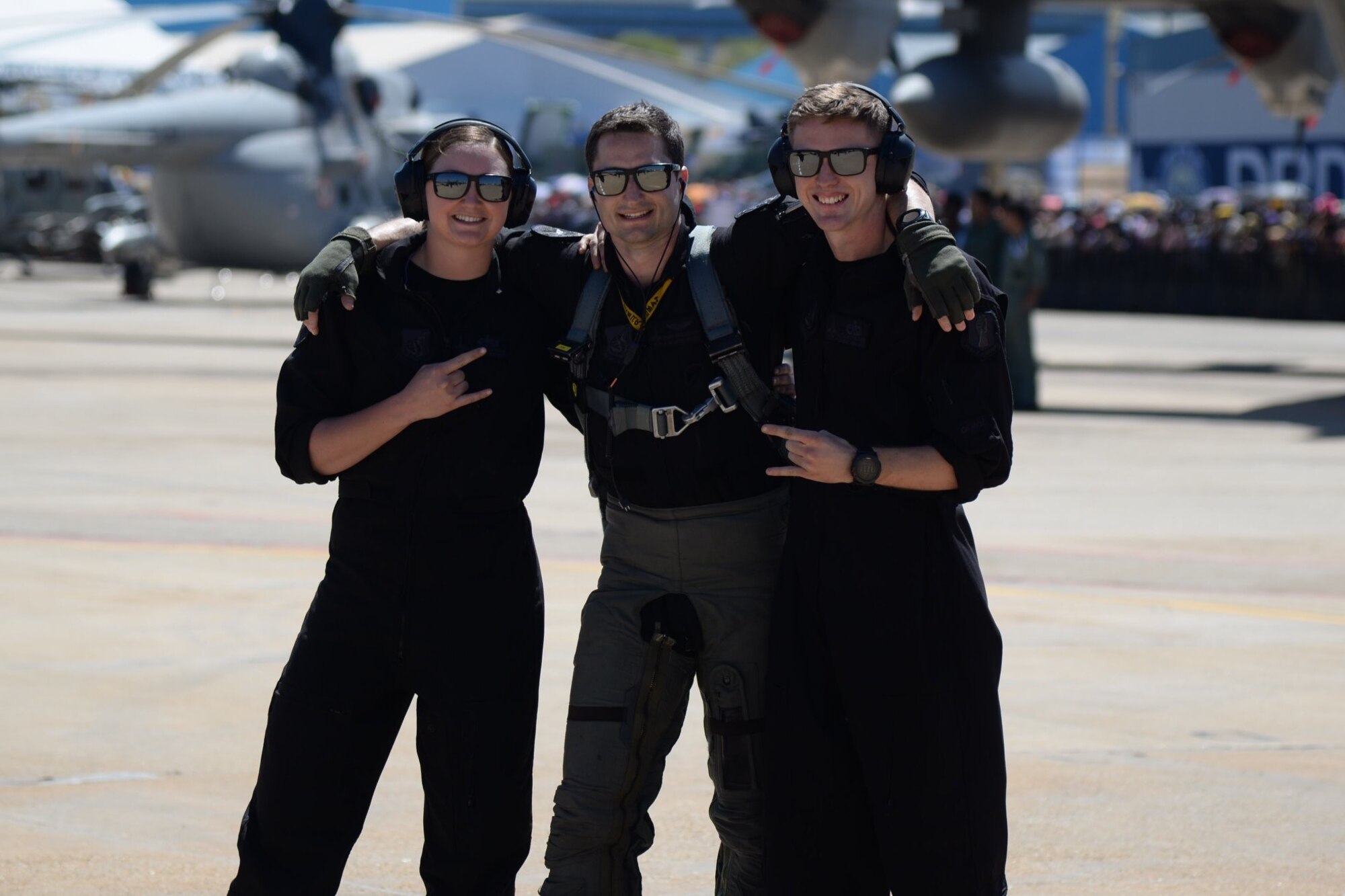 U.S. Air Force Staff Sgt. Emily Wall, left, former lead crew chief, Capt. Jacob “Primo” Impellizzeri, center, commander and pilot, and Staff Sgt. Dane Pendzinski, right, crew chief, all with the Pacific Air Forces F-16 Fighting Falcon Demonstration Team, pause for a photo at the Aero India Air Show, India, Feb. 23, 2019. Impellizzeri and his team have travelled to South Korea, Alaska, New Zealand, India, Thailand, Guam, the United Kingdom and multiple Japan prefectures to promote cohesion, unity and friendship between the U.S. and its’ allies. (Courtesy photo)