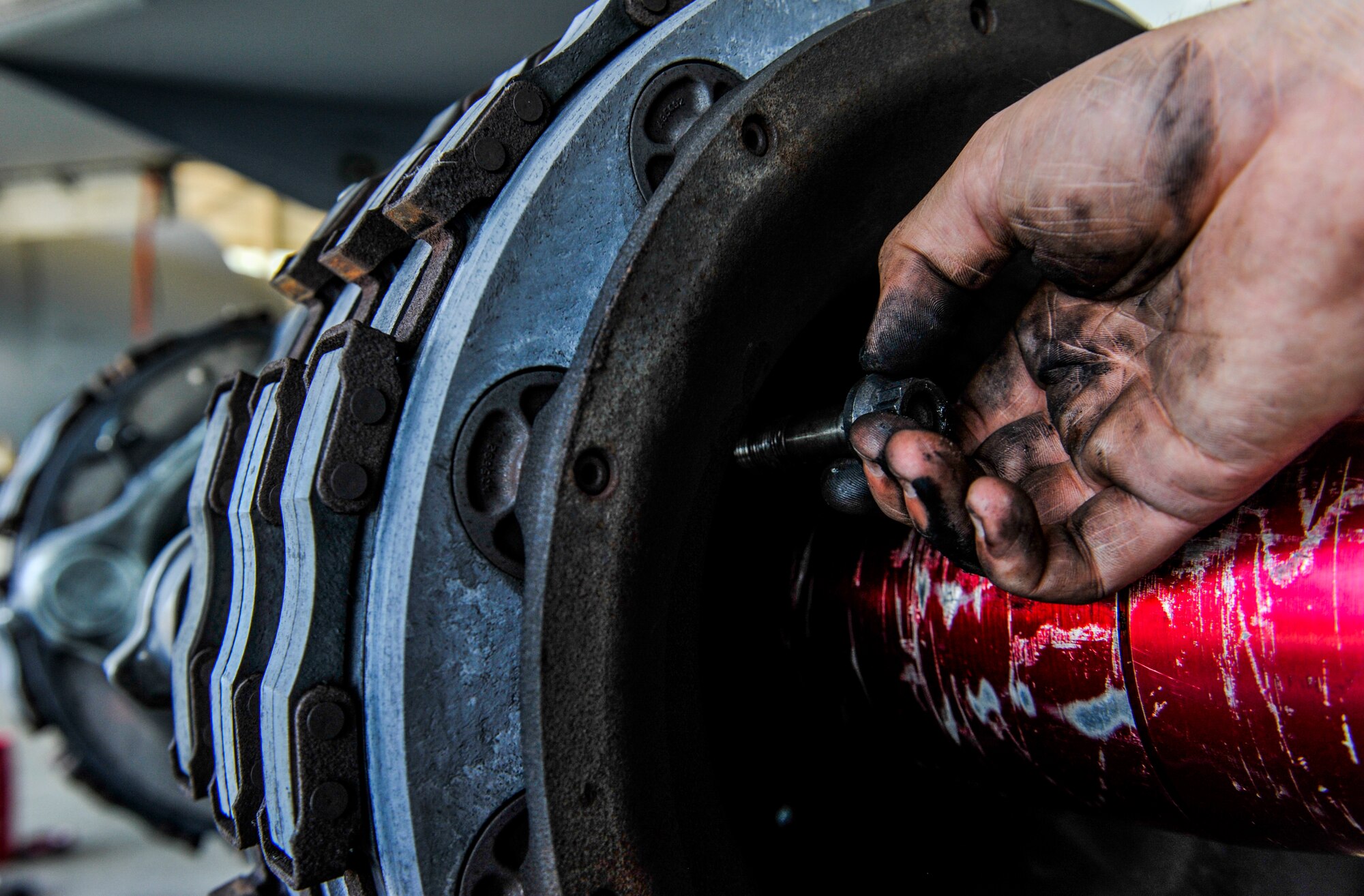 U.S. Air Force Airman 1st Class Andrew Roberts, aircraft inspection apprentice assigned to the 18th Equipment Maintenance Squadron, unscrews a bolt from a KC-135 Stratotanker during an isochronal inspection at Kadena Air Base, Japan, May 22, 2019.