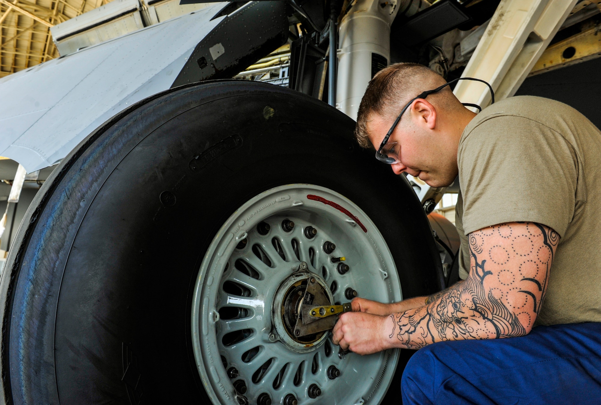 U.S. Air Force Airman 1st Class Andrew Roberts, aircraft inspection apprentice assigned to the 18th Equipment Maintenance Squadron, unscrews bolts from a wheel cap of KC-135 Stratotanker during an isochronal inspection at Kadena Air Base, Japan, May 22, 2019.