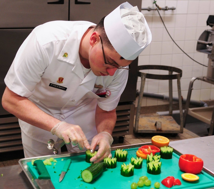 Spc. Dustin Freeman a cook with the 66th Transportation Company prepares garnishing for the lunch menu during the final evaluation of the Philip A. Connelly Award competition at the Clock Tower Cafe, Kleber-Kaserne.