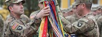 Lt. Col. Robert Tracy, Commander (left), and Command Sgt. Maj. Darren Pleskach, Command Sergeant Major (right), uncased their unit colors during a ceremony here, May 2.