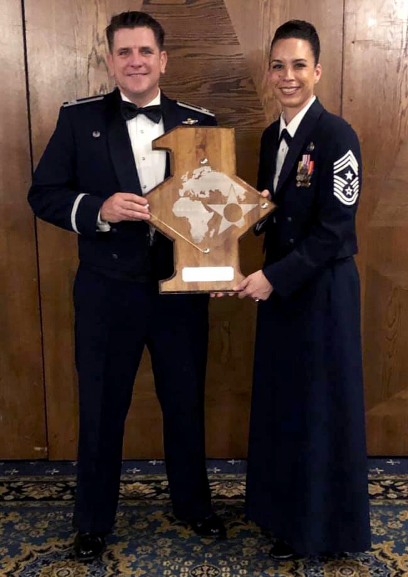 U.S. Air Force Col. Christopher Amrhein, 100th Air Refueling Wing commander, and Chief Master Sgt. Kristina Rogers, 100th ARW command chief, receive the USAFE-AFAFRICA First Sergeants Council Award on behalf of the RAF Mildenhall First Sergeant Council at Ramstein Air Base, Germany, May 9, 2019. The award was presented for the outstanding performance of the 100th ARW First Sergeants Council in improving wing morale and increasing mission effectiveness. (Courtesy photo)