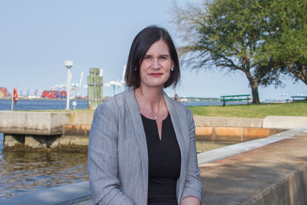 Woman stands by waterfront in Norfolk, Virginia.