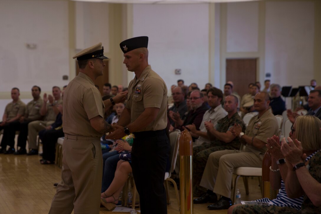 Command Master Chief Petty Officer Russell Folley shakes a Sailor’s hand after conducting “The Watch” during his retirement ceremony on Camp Lejeune, N.C., May 24, 2019. Folley, a St. Martinville, Louisiana native, is retiring after 33 years of service in the U.S. Navy. Folley described one of the favorite things in his career was watching both Marines and junior Sailors succeed. He added at the end of his speech during the ceremony that his best moments in the Navy were while wearing Marine pattern utilities. (U.S. Marine photo by Cpl. Leynard Plazo)