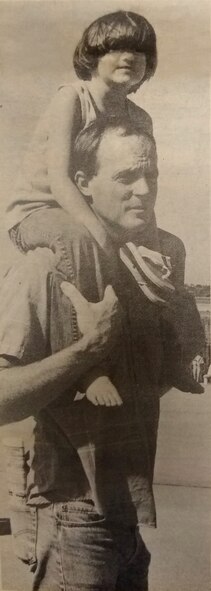 Photo caption from Sept. 18, 1987 edition of the Tinker Take Off base newspaper: When the crowds became so dense around the air shows, 6-year-old Lauren found it easier to see on her father David Kelly’s back. (U.S. Air Force photo digitally restored for clarity/Darla R. Booker)