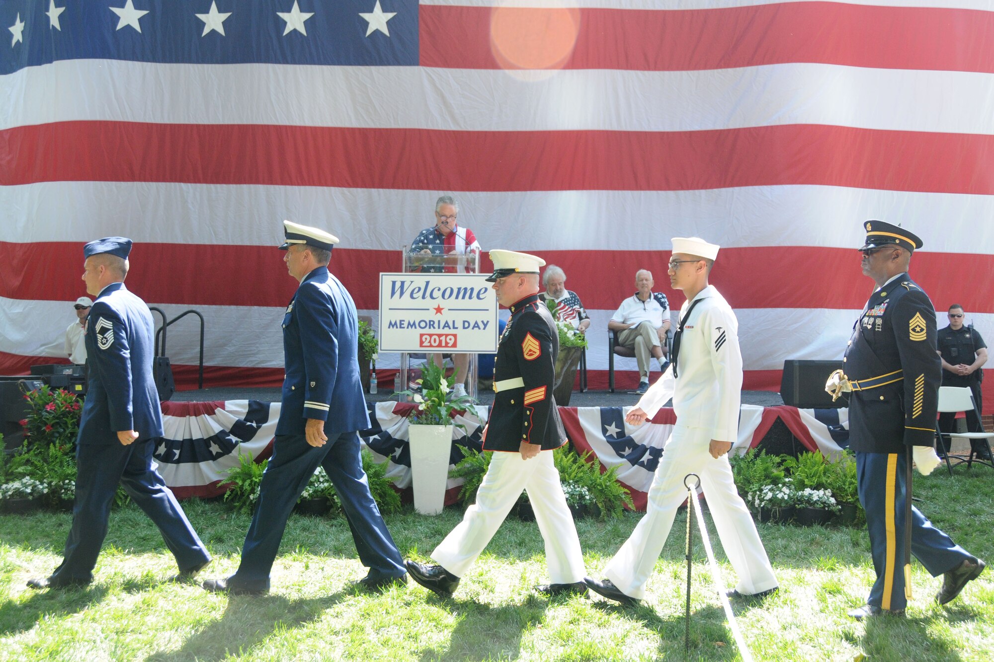 Members of the five branches of the U.S. military walk in unison as part of the Roswell Memorial Day Ceremony at Roswell City Hall area, Roswell, Georgia on May 27, 2019. At the event, all branches of the military were represented and individual service representatives from each branch participated in the mixed service recognition portion of the program. (U.S. Air Force photo by Senior Airman Justin Clayvon)