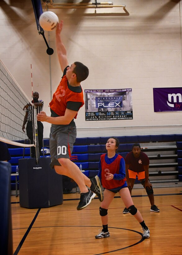 Staff Sgt. Tyler Hambidge, 932nd Medical Squadron, spikes the volleyball back over the net and scores a point May 16, 2019, at Scott Air Force Base, Ill., as Senior Airman Katie Baskerville tracks the ball trajectory.   "My thoughts about this year’s volleyball team is this: It doesn’t matter about the wins or the losses. What matters is that we all have fun and as cliché as that may sound it’s why we play and continue to do so," said Baskerville. (U.S. Air Force photo by Lt. Col. Stan Paregien)