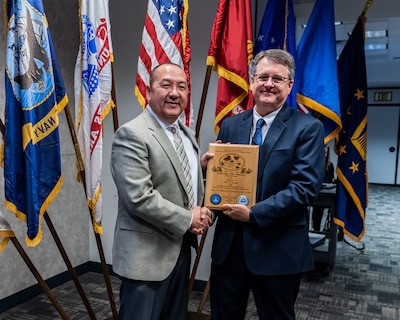 The Shoong Yin award winner being presented with the award by a member of the DLA Land and Maritime command staff.