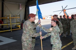 Maj. Amoreena York, Aviation Company (AVCO) commander, Task Force Sinai, passes the AVCO guidon to Col. Mark Ott, Task Force Sinai commander, symbolizing the relinquishment of command at South Camp, Egypt, May 23, 2019. AVCO supports rotary-wing aviation mission requirements for the Multinational Force & Observers (MFO). The MFO is headquartered in Rome, is an independent international organization, created by agreement between the Arab Republic of Egypt and the State of Israel, with peacekeeping responsibilities in the Sinai.