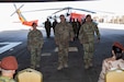 Maj. Amoreena York, Col. Mark Ott, and Maj. Mark Axtell walk to their seats after passing the guidon signaling the transfer of leadership of Aviation Company (AVCO), Task Force Sinai,  South Camp, Egypt, May 23, 2019. AVCO is a self-sustaining aviation company, enhanced with all the support elements of a traditional aviation battalion.