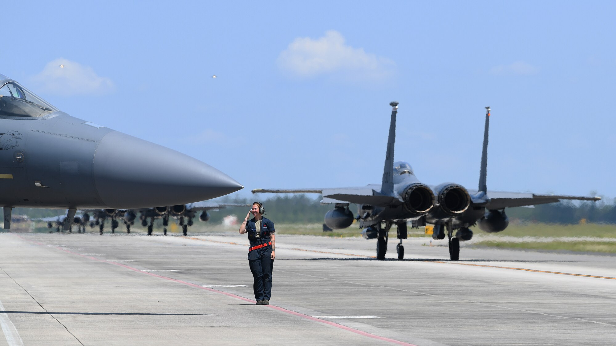 A 494th Aircraft Maintenance Unit crew chief salutes an F-15E Strike Eagle aircrew at Tyndall Air Force Base, Florida, May 20, 2019. The 494th AMU participated in exercise Checkered Flag 19-1, allowing maintenance personnel assigned to the 494th AMU to be evaluated through the Weapons Systems Evaluation Programs verifying weapon system performance, determine reliability, evaluate capability . (U.S. Air Force photo by Airman 1st Class Shanice Williams-Jones)