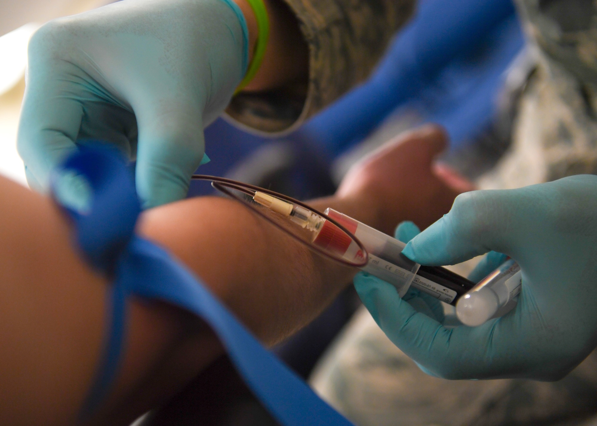 Washington Air National Guard Technical Sgt. Ray Ordonia, 194th Medical Group medic, draws blood during a 194th Medical Group periodic health assessment rodeo, Camp Murray, Washington, May 4, 2019. The PHA rodeo is an annual event used to accomplish Airman medical readiness requirements. (U.S. Air National Guard photo by Senior Airman Justyn M. Freeman)