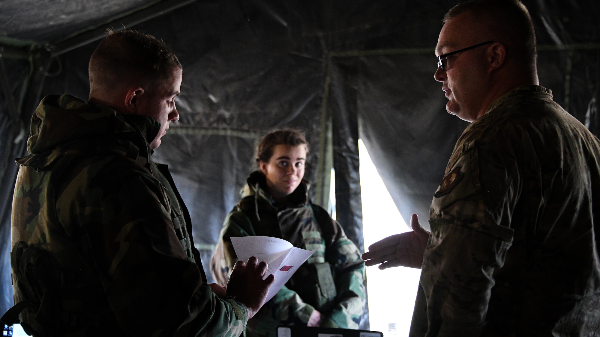 Senior Airman Lucas Gross, left, works with an "angry customer," Master Sgt. David Baker, during a Contracting Directorate field exercise at Hill Air Force Base, Utah, May 22, 2019. The exercise simulated scenarios specific to the contracting mission in a deployed environment. Contracting specialists purchase supplies and services essential to operational continiuty and mission success. (U.S. Air Force photo by R. Nial Bradshaw)