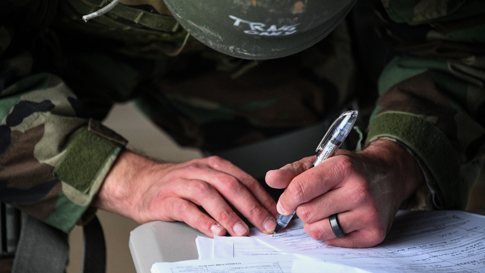 An Airman fills out paperwork during a Contracting Directorate field exercise at Hill Air Force Base, Utah, May 22, 2019. The exercise simulated scenarios specific to the contracting mission in a deployed environment. Contracting specialists purchase supplies and services essential to operational continiuty and mission success. (U.S. Air Force photo by R. Nial Bradshaw)