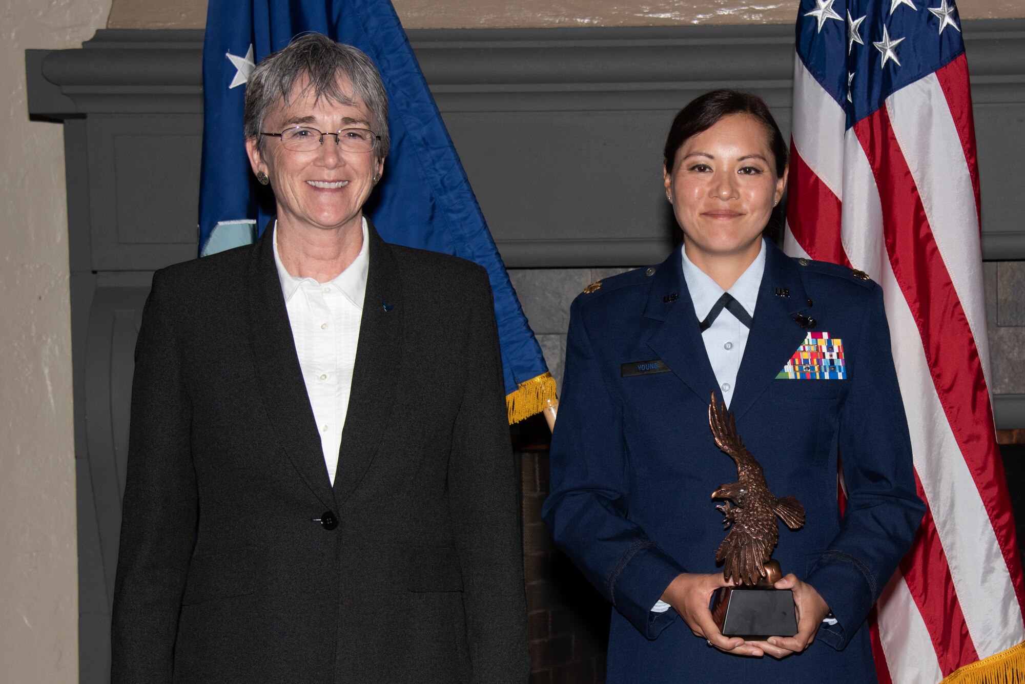 Secretary of the Air Force Heather Wilson, left, presents Maj. Paige Young, Air Command and Staff College student, right, with the 2019 Secretary of the Air Force Leadership Award May 14, 2019, at Maxwell Air Force Base, Alabama. Young was responsible for co-hosting podcasts on hypersonic weapons research and new a new Air Force career field, organized the ACSC Holiday food drive and an ACSC Hurricane Michael relief effort, gathering more than 320 pounds of food for the local Montgomery community.