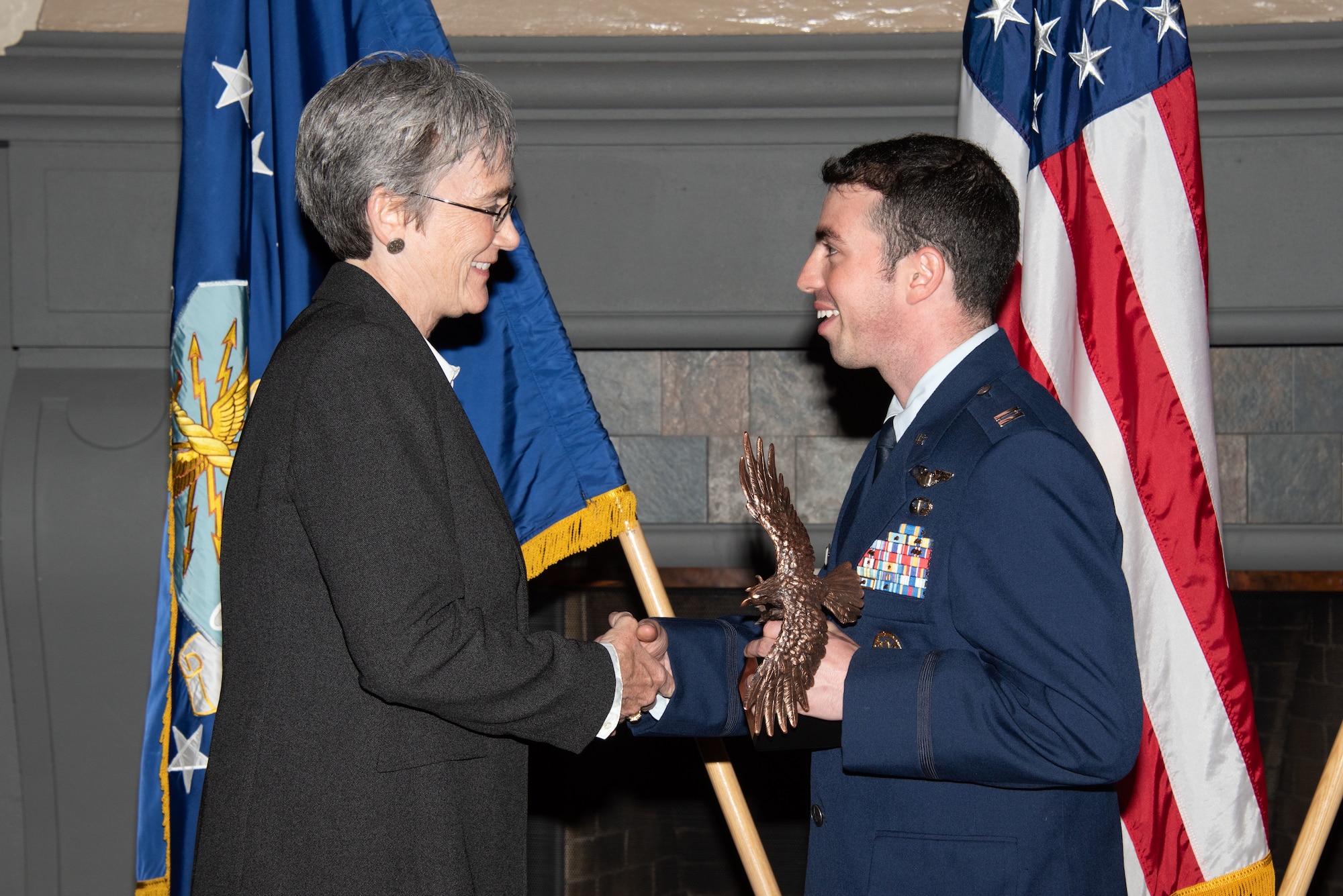 Secretary of the Air Force Heather Wilson, left, presents Capt. Julian Gluck, Squadron Officer School student, right, with the 2019 Secretary of the Air Force Leadership Award May 14, 2019, at Maxwell Air Force Base, Alabama. Gluck was the number-one graduate in his class of 3,803 Air Force captains, international officers and Department of the Air Force civilian students. He also distinguished himself as an Outstanding Contributor in his flight, Distinguished Graduate and his class’ Commandant Leadership Award winner.