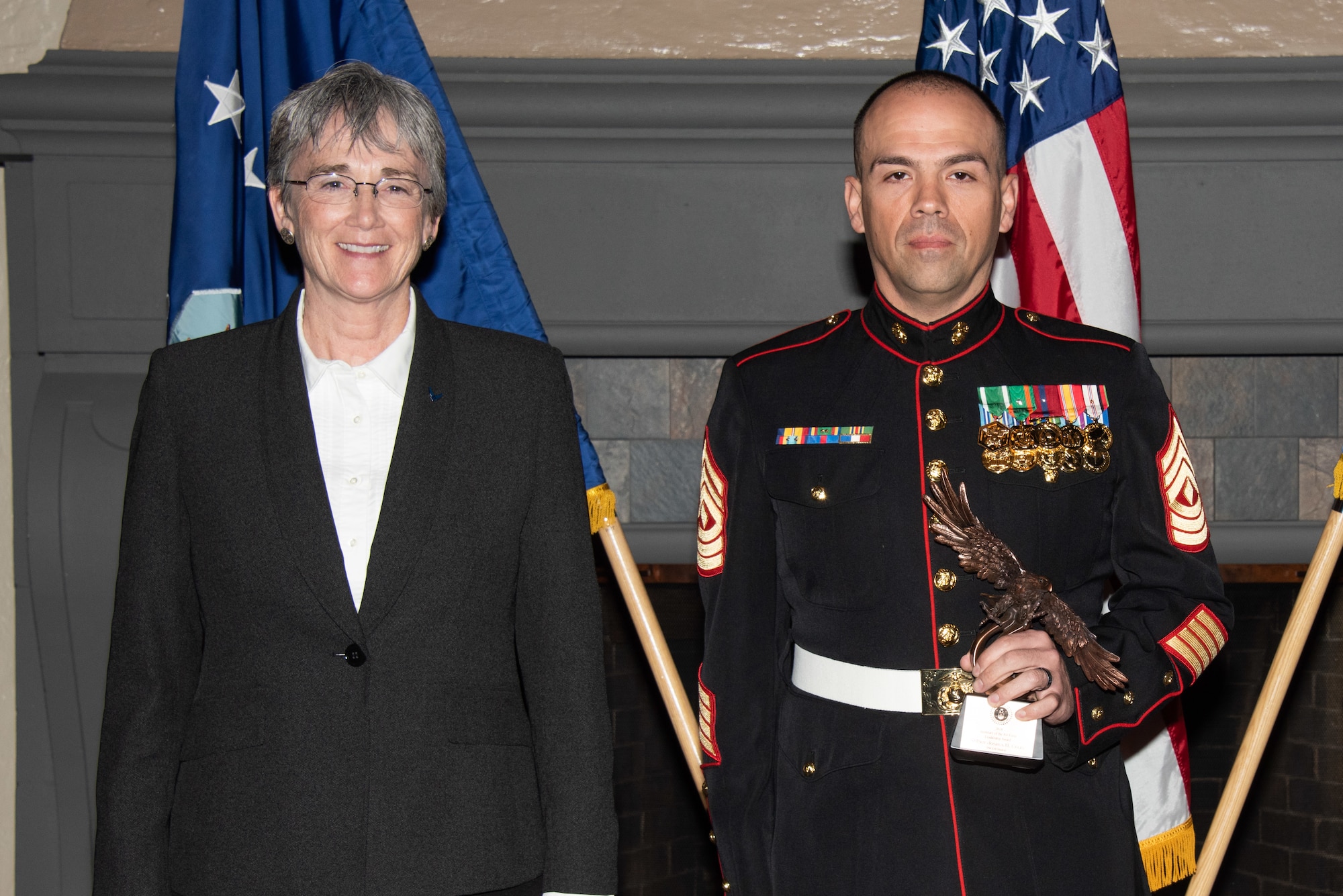 Secretary of the Air Force Heather Wilson, left, presents U.S. Marine Corps First Sgt. Joshua Celis, Air Force Senior Non-Commissioned Officer Academy student, right, with the 2019 Secretary of the Air Force Leadership Award May 14, 2019, at Maxwell Air Force Base, Alabama. Celis distinguished himself as the most outstanding graduate of the 18-Charile SNCOA class of 1,759 students through professionalism, integrity and leadership ability. He mastered the Advanced Leadership Curriculum during the course, earning a 94.7 grade point average with an instructor rating of 96.5 percent. Celis also helped mentor 669 Company Grade Officers and teammates in leadership skills through academics, strategic study groups and real-world emergent leader events.