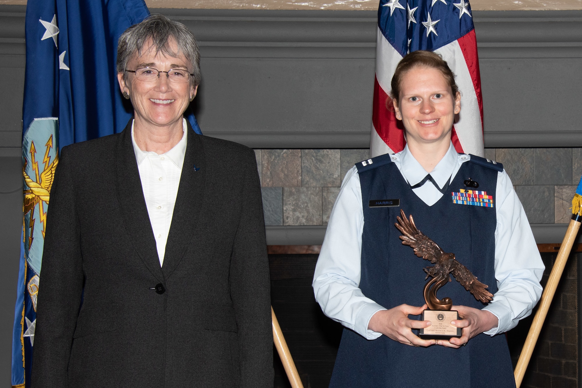 Secretary of the Air Force Heather Wilson, left, presents Capt. Jessica Harris, Air University Dependent and Sponsorship Programs chief, right, with the 2019 Secretary of the Air Force Leadership Award May 14, 2019, at Maxwell Air Force Base, Alabama. Harris transformed AUs support to international officers and dependents, increasing social and education opportunities while reducing human resource requirements. She also managed 147 volunteers in support of 179 international students, bolstering partnerships with 91 nations, directed a 12-week English course for 42 dependents, and streamlined family orientation, instituting the first-ever community information fair.