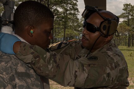 U.S. Army Sgt. 1st Class Phillip Webb, 1st Battalion 228th Aviation Regiment detachment first sergeant, applies a dressing to a simulated neck wound during a search and rescue exercise, May 21, 2019, in Comayagua, Honduras. Members from various units on Joint Task Force – Bravo participated in the exercise that simulated a HH-60 Blackhawk crashed during a routine flight carrying personnel. The exercise practiced notification, recall, search and rescue, on-scene medical care, recovery of personnel from low and high angle austere terrain, and medical care once the injured returned to base. (U.S. Air Force photo by Staff Sgt. Eric Summers Jr.)