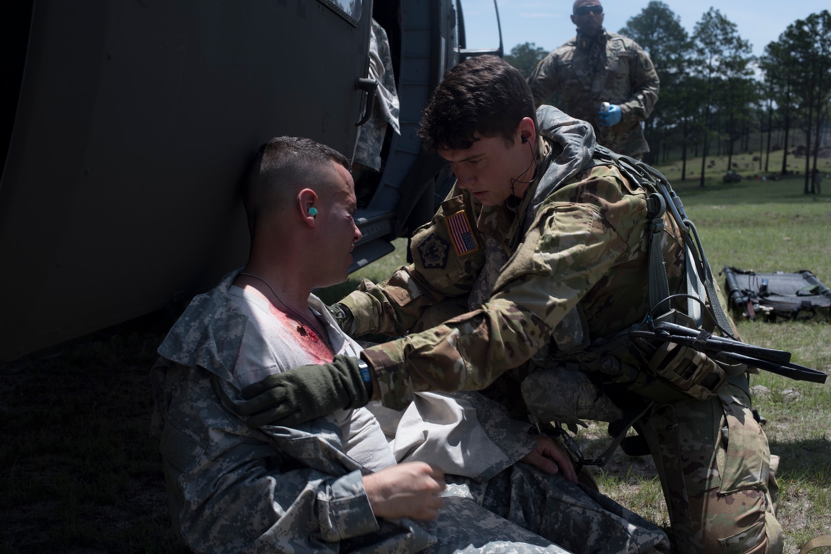 U.S. Army Sgt. Alicia Baum, 1st Battalion 228th Aviation Regiment flight paramedic, assess the injuries of a simulated aircraft casualty during a search and rescue exercise, May 21, 2019, in Comayagua, Honduras. Members from various units on Joint Task Force – Bravo participated in the exercise that simulated a HH-60 Blackhawk crashed during a routine flight carrying personnel. The exercise practiced notification, recall, search and rescue, on-scene medical care, recovery of personnel from low and high angle austere terrain, and medical care once the injured returned to base. (U.S. Air Force photo by Staff Sgt. Eric Summers Jr.)