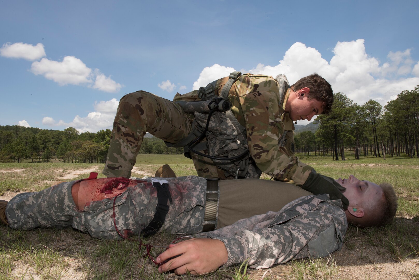 U.S. Army Sgt. Alicia Baum, 1st Battalion 228th Aviation Regiment flight paramedic, analyzes the condition of a simulated aircraft casualty during a search and rescue exercise, May 21, 2019, in Comayagua, Honduras. Members from various units on Joint Task Force – Bravo participated in the exercise that simulated a HH-60 Blackhawk crashed during a routine flight carrying personnel. The exercise practiced notification, recall, search and rescue, on-scene medical care, recovery of personnel from low and high angle austere terrain, and medical care once the injured returned to base. (U.S. Air Force photo by Staff Sgt. Eric Summers Jr.)
