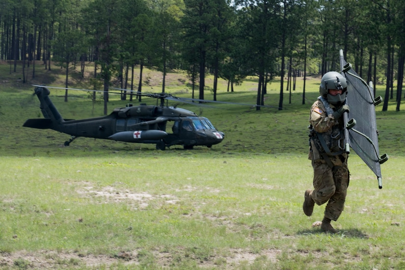 A U.S. Army medic carries a stretcher to the location of a simulated aircraft casualty during a search and rescue exercise, May 21, 2019, in Comayagua, Honduras. Members from various units on Joint Task Force – Bravo participated in the exercise that simulated a HH-60 Blackhawk crashed during a routine flight carrying personnel. The exercise practiced notification, recall, search and rescue, on-scene medical care, recovery of personnel from low and high angle austere terrain, and medical care once the injured returned to base. (U.S. Air Force photo by Staff Sgt. Eric Summers Jr.)
