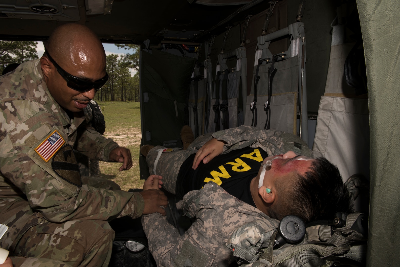 U.S. Army Sgt. 1st Class Phillip Webb, 1st Battalion 228th Aviation Regiment detachment first sergeant, feels for the pulse of a simulated aircraft casualty during a search and rescue exercise, May 21, 2019, in Comayagua, Honduras. Members from various units on Joint Task Force – Bravo participated in the exercise that simulated a HH-60 Blackhawk crashed during a routine flight carrying personnel. The exercise practiced notification, recall, search and rescue, on-scene medical care, recovery of personnel from low and high angle austere terrain, and medical care once the injured returned to base. (U.S. Air Force photo by Staff Sgt. Eric Summers Jr.)