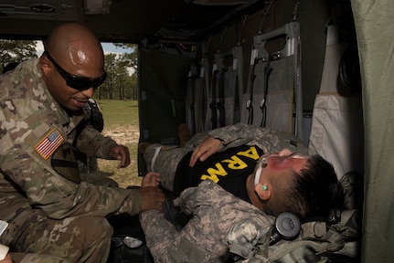 U.S. Army Sgt. 1st Class Phillip Webb, 1st Battalion 228th Aviation Regiment detachment first sergeant, feels for the pulse of a simulated aircraft casualty during a search and rescue exercise, May 21, 2019, in Comayagua, Honduras. Members from various units on Joint Task Force – Bravo participated in the exercise that simulated a HH-60 Blackhawk crashed during a routine flight carrying personnel. The exercise practiced notification, recall, search and rescue, on-scene medical care, recovery of personnel from low and high angle austere terrain, and medical care once the injured returned to base. (U.S. Air Force photo by Staff Sgt. Eric Summers Jr.)