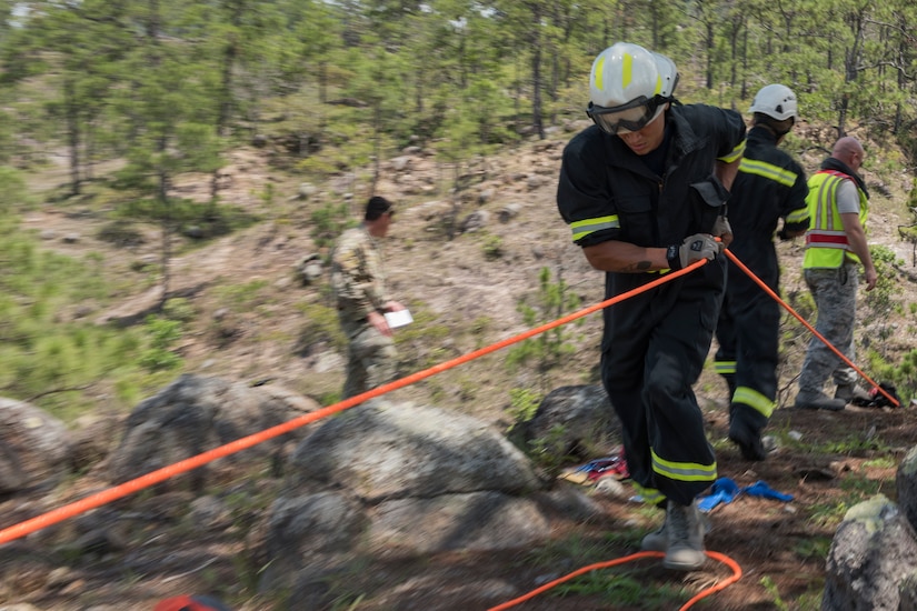 U.S. Air Force Staff Sgt. Spencer Highsmith, 612th Air Base Squadron firefighter, uses a rope to help raise a gurney during a search and rescue exercise, May 21, 2019, in Comayagua, Honduras. Members from various units on Joint Task Force – Bravo participated in the exercise that simulated a HH-60 Blackhawk crashed during a routine flight carrying personnel. The exercise practiced notification, recall, search and rescue, on-scene medical care, recovery of personnel from low and high angle austere terrain, and medical care once the injured returned to base. (U.S. Air Force photo by Staff Sgt. Eric Summers Jr.)