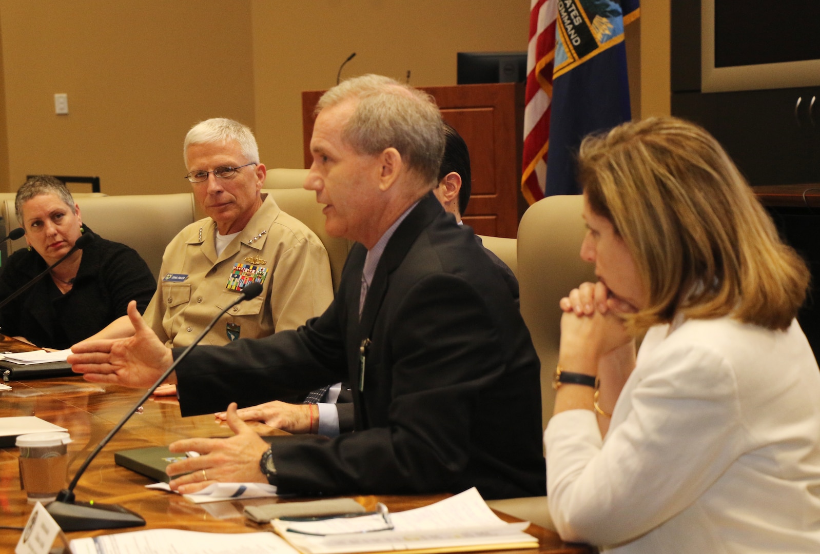 U.S. Navy Adm. Craig Faller listens to Steve Olive, Acting Assistant Administrator for USAID.
