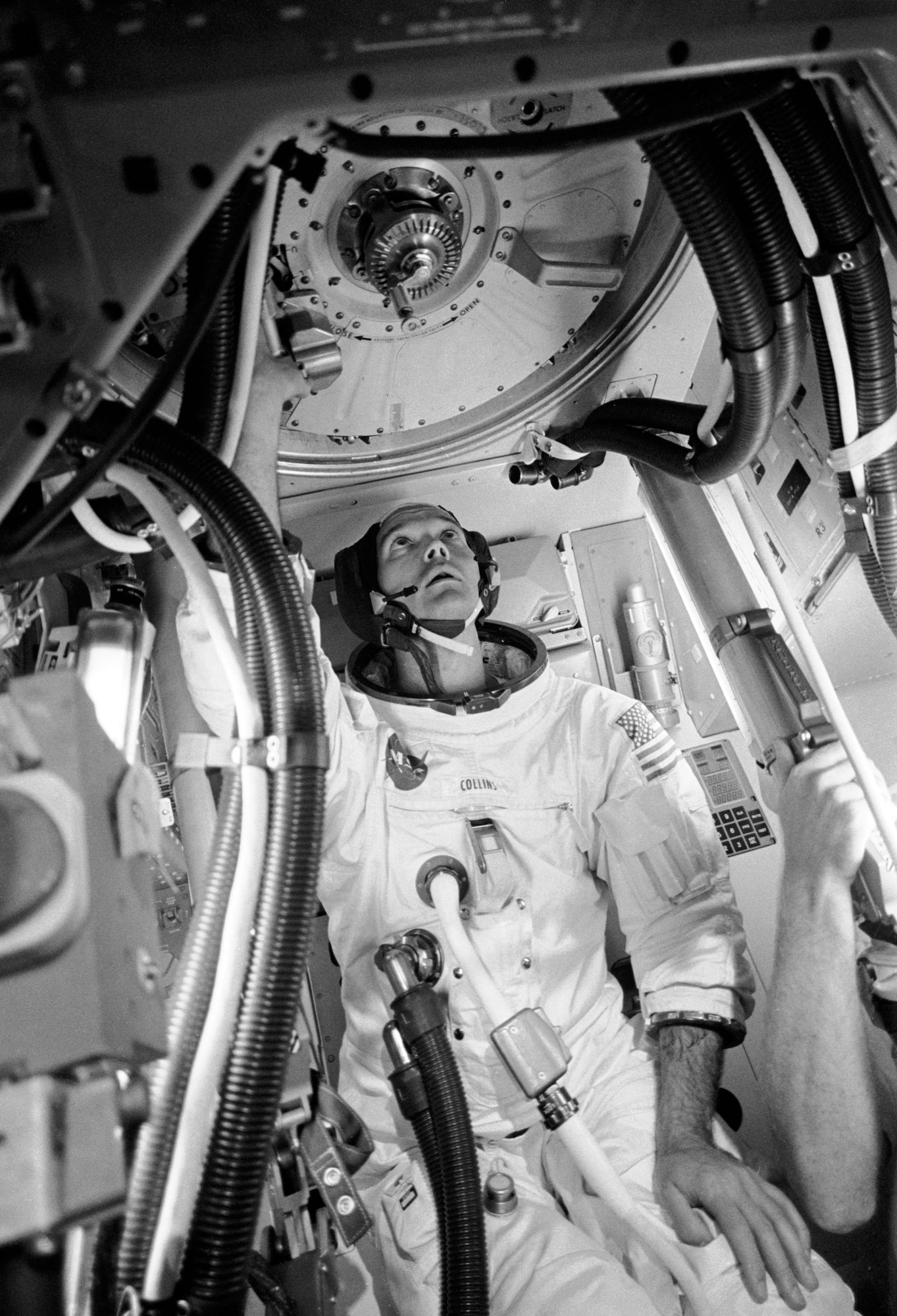Apollo 11 Command Module Pilot and USAF Col. (later Maj. Gen.) Michael Collins trains in his A7L suit. The circular hatch above his head is at the top of the cone-shaped Apollo spacecraft.(Contributed photo)