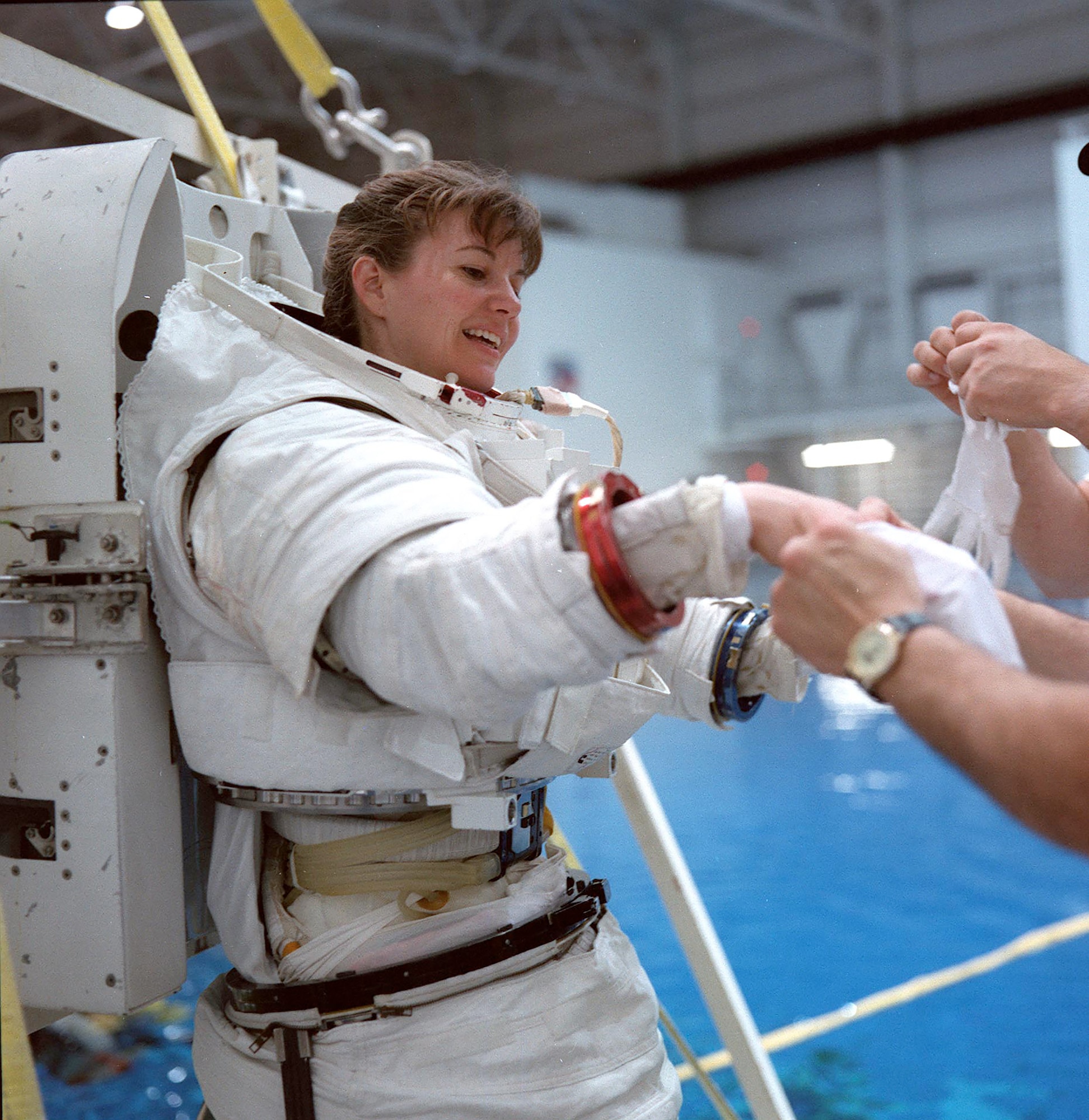 The Space Shuttle EMU was a modular system with separate upper and lower body components. Here, USAF astronaut Col. Catherine “Cady” Coleman prepares for EMU training.(Contributed photo)