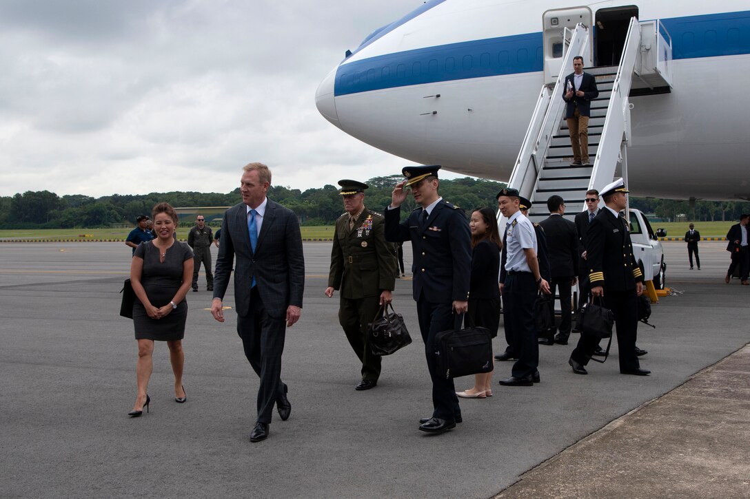 Acting Defense Secretary Patrick M. Shanahan walks away from an airplane after arriving in Singapore.