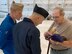 World War II veteran Robert Henley shows off his prized “30 years with no deficiencies” pin to Blue Angels #7 pilot Lt. Cary Rickoff, left, and crew chief Petty Officer 2nd Class Kyle Wood. Henley, who spent 30 years as a civilian at Tinker Air Force Base, has a bucket list dream of flying in an F-18.