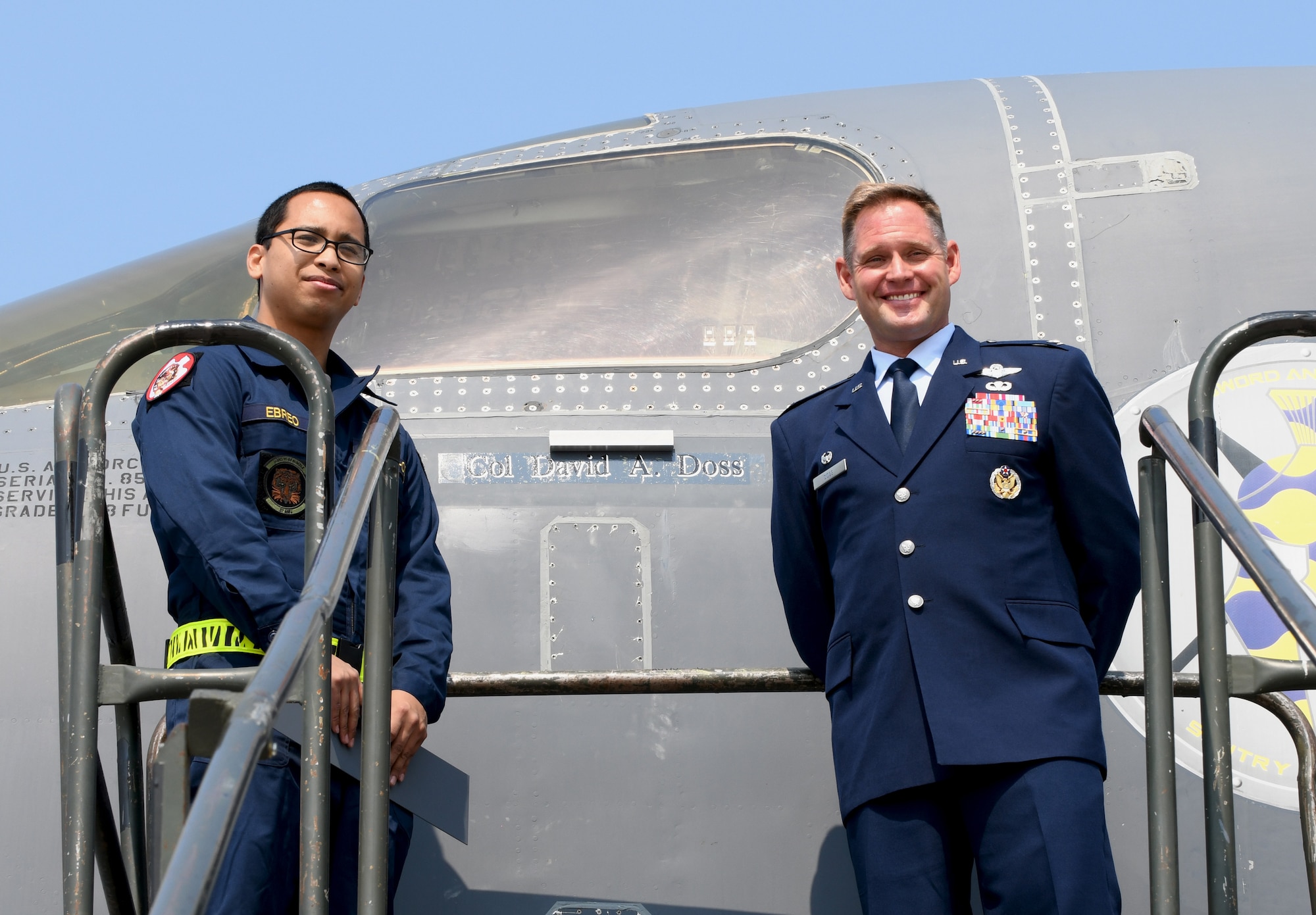 Airman 1st Class Marofrancesco Ebreo, a 28th Aircraft Maintenance Squadron dedicated crew chief, stands alongside Col. David A. Doss, the 28th Bomb Wing commander, during a name reveal on a B-1B Lancer at Ellsworth Air Force Base., S.D., May 30, 2019.  Doss is a master navigator successfully completing more than 2,500 flight hours, including 380 in combat. (U.S. Air Force photo by Airman 1st Class Christina Bennett)