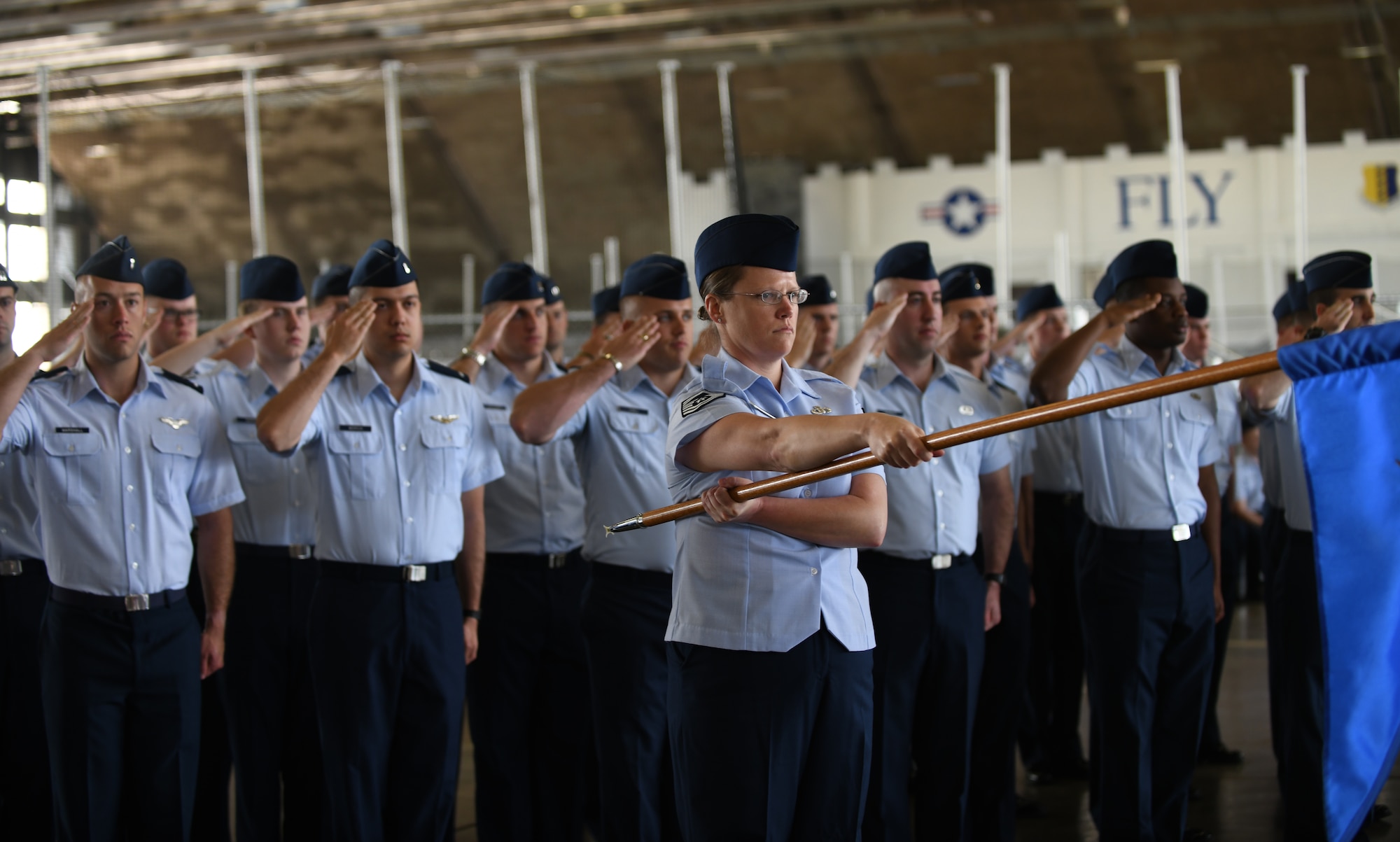 A formation of Airmen from the 28th Operations Group render a salute during a change of command ceremony at Ellsworth Air Force Base, S.D., May 30, 2019. The ceremony is a time-honored military tradition that serves as representation of the exchange of responsibility and authority from one commander to another. (U.S. Air Force photo by Airman 1st Class Christina Bennett)