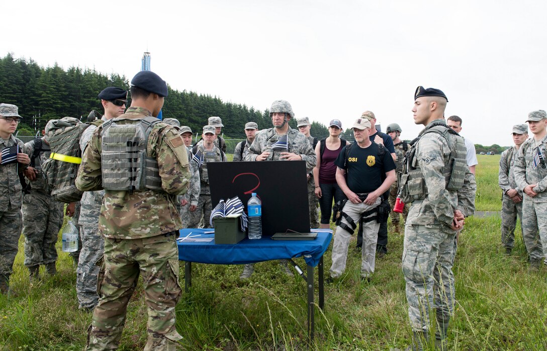 Airman Noah Hernandez, 374th Security Forces Squadron patrolman, briefs participants on the photos of SFS’s airmen who died in service to the country during Yokota’s 2019 National Police Week 5K Ruck March, May 20, 2019, at Yokota Air Base, Japan.