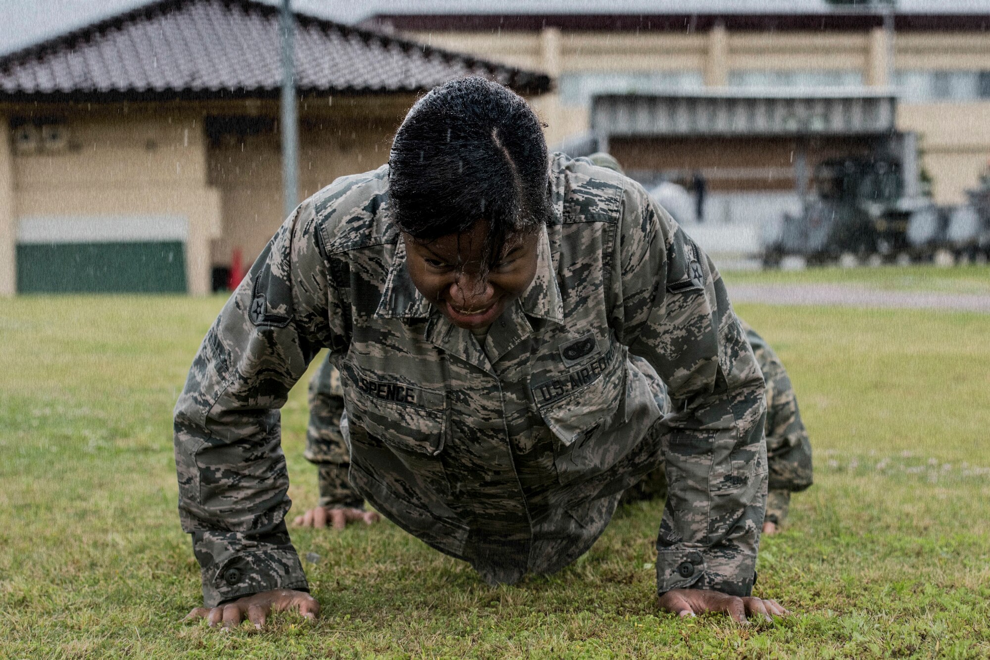 Airman Wanisha Spence, 374th Security Forces Squadron response force member, performs team pushups during Yokota’s 2019 National Police Week Defenders Challenge at Yokota Air Base, Japan, May 21, 2019.