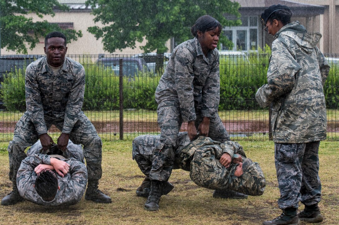 Airmen from 374th Security Forces Squadron perform buddy deadlifts during the Defenders Challenge as part of National Police Week at Yokota Air Base, Japan, May 21, 2019.