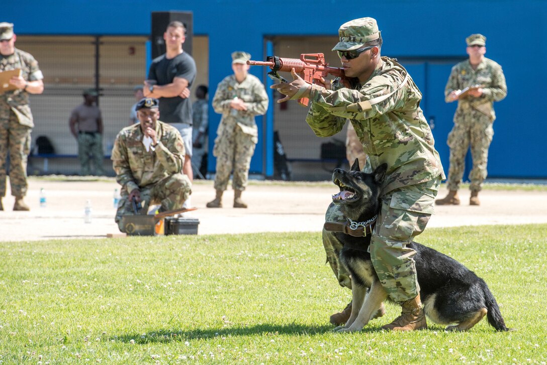 U.S. Army Spc. Valdo DeBarros, 901st Military Police Detachment military working dog handler, patrols with MWD, Buzo, during Yokota's 2019 National Police Week Top Dog competition, May 24, 2019, at Yokota Air Base, Japan.