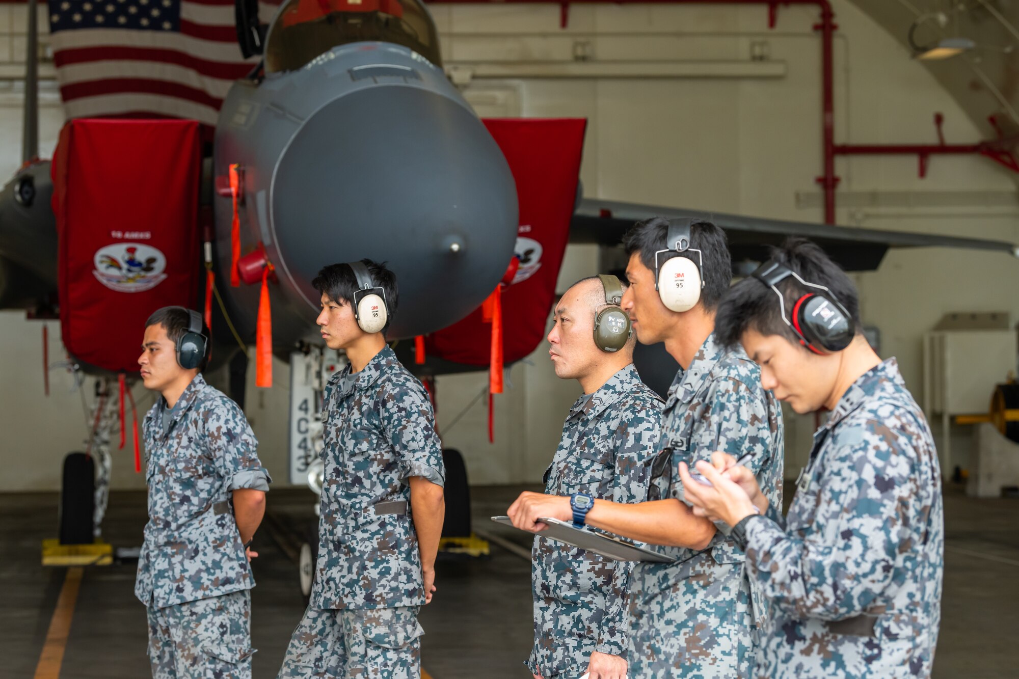 Japan Air Self-Defense Force members watch a load demonstration during the first bilateral weapons load exchange between Kadena Air Base and the JASDF, May 23, 2019. The goal of the training is to accurately and safely load munitions while strengthening the U.S.-Japan alliance in order to secure a free-and-open Indo-Pacific. (U.S. Air Force photo by Airman 1st Class Matthew Seefeldt)
